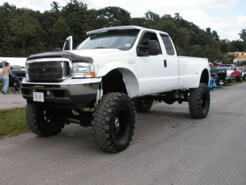 1994 Ford Bronco - This lifted 2002 Ford F-350 Super Duty truck features oversized tires and a prominent grille.