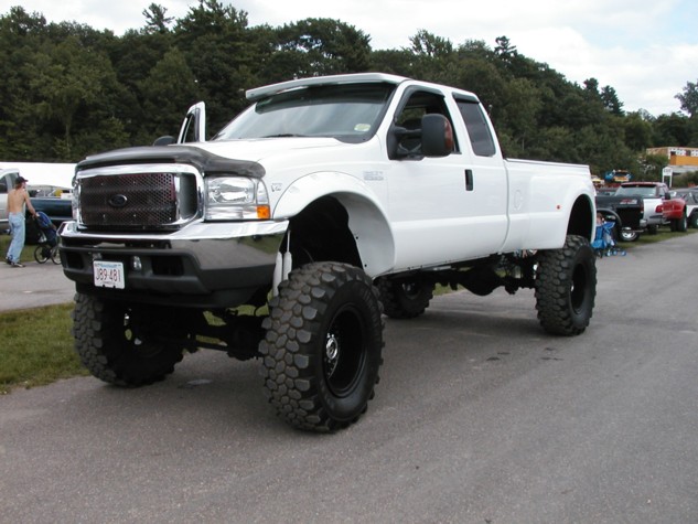 White lifted 2002 Ford F-350 Super Duty truck with large tires