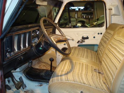 1979 Ford Bronco - The interior of a 1979 Ford Bronco shows its distinctive striped upholstery and dashboard details.