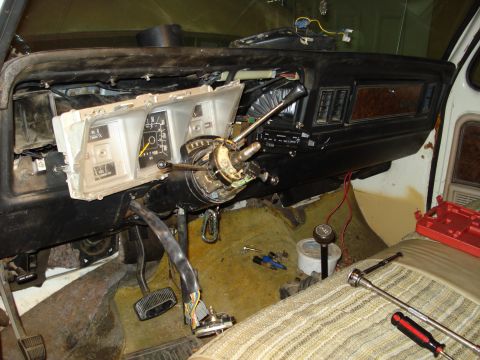1979 Ford Bronco - Interior of a late-1970s Ford truck mid-repair with the instrument cluster pulled out of the dash and the steering wheel removed, exposing…