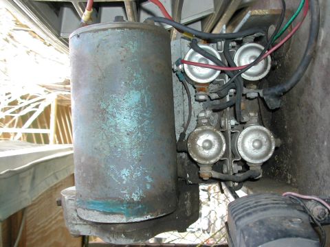 1979 Ford Bronco - Close-up view of a winch motor and associated solenoids, showing electrical connections and weathered metal components.
