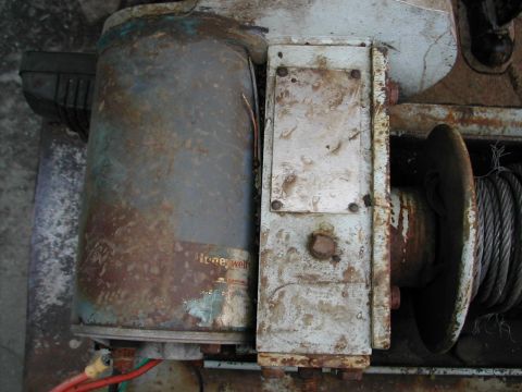 1979 Ford Bronco - This old winch shows significant rust and wear, with a visible Honeywell label on its motor.