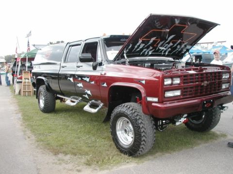 1994 Ford Bronco - This custom pickup truck features a two-tone paint job and a lifted suspension.