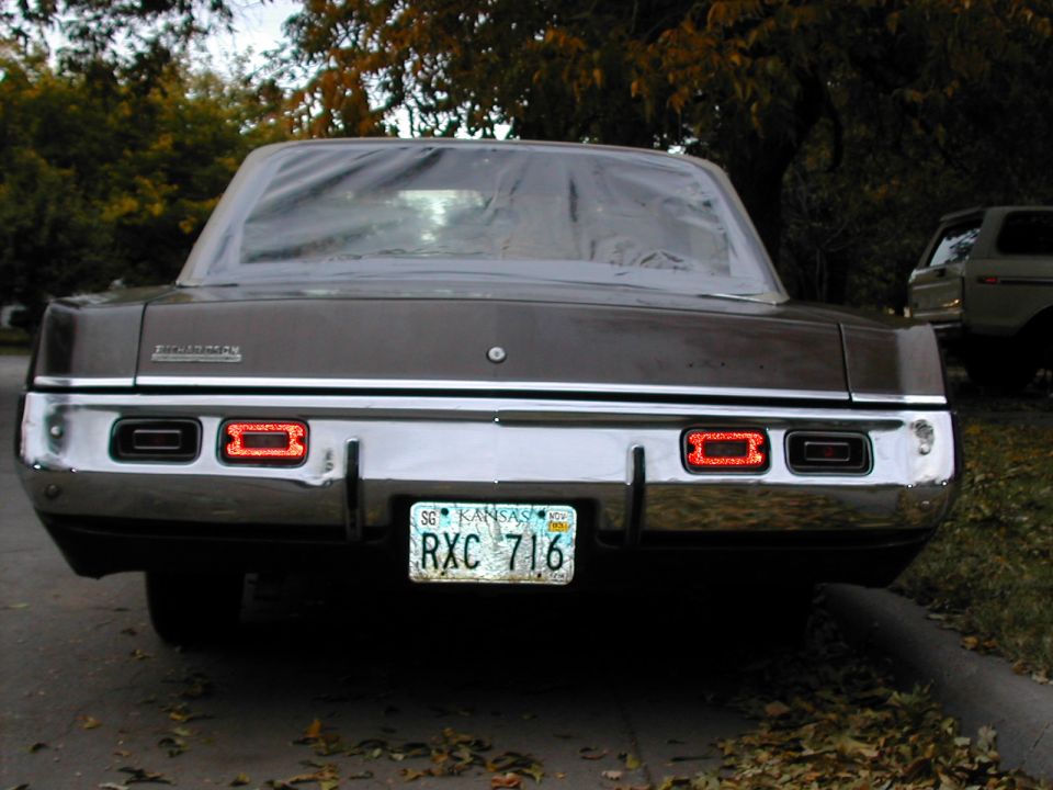 1971 Dodge Dart rear view, brown sedan with rectangular taillights and chrome bumper