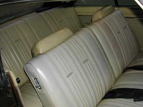 1971 Dodge Dart - The interior of a 1971 Dodge Dart shows light-colored pleated bench seats and headrests.