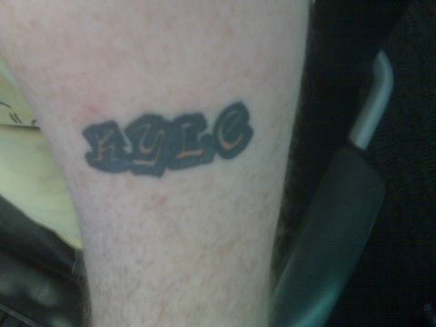 2001 Ford Crown Victoria - Graffiti-style tattoo on an arm.
