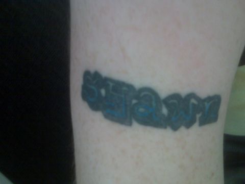 2001 Ford Crown Victoria - A tattoo with the word 'slam' is visible on a person's skin.