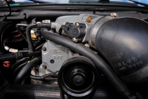 2007 Ford Mustang - Close-up view of a Ford SVT engine component, showing the supercharger and intake piping.