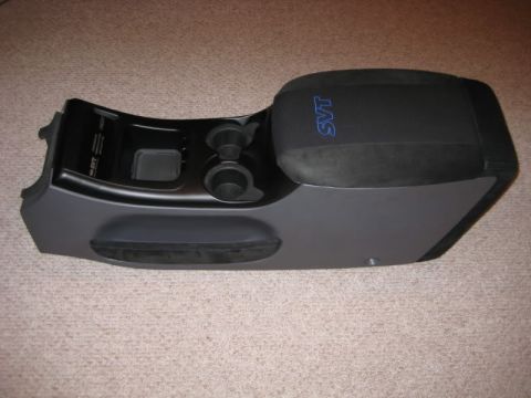 2007 Ford Mustang - Center console part with SVT logo, likely from a Ford Mustang.