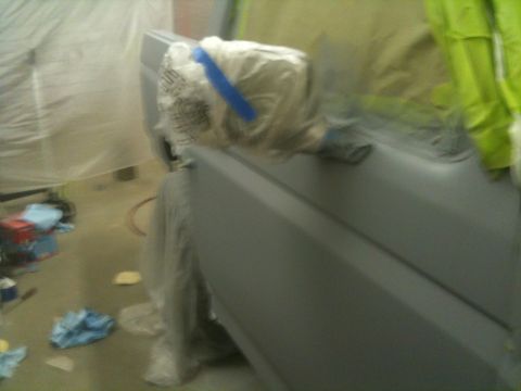 1993 Ford Bronco - Vehicle door covered in plastic and primer, ready for paint work.