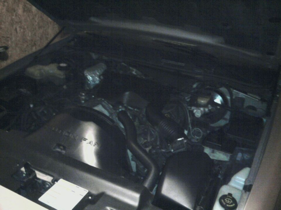 1996 Mercury Grand Marquis engine bay with hood open, showing fan shroud and engine components