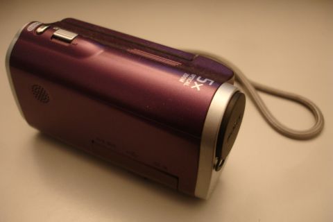 1993 Ford Taurus - Purple camcorder with 5x optical zoom and a wrist strap is shown on a light-colored surface.