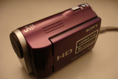 1993 Ford Taurus - A close-up view of a purple Sony Handycam camcorder, highlighting its optical zoom and HD features.