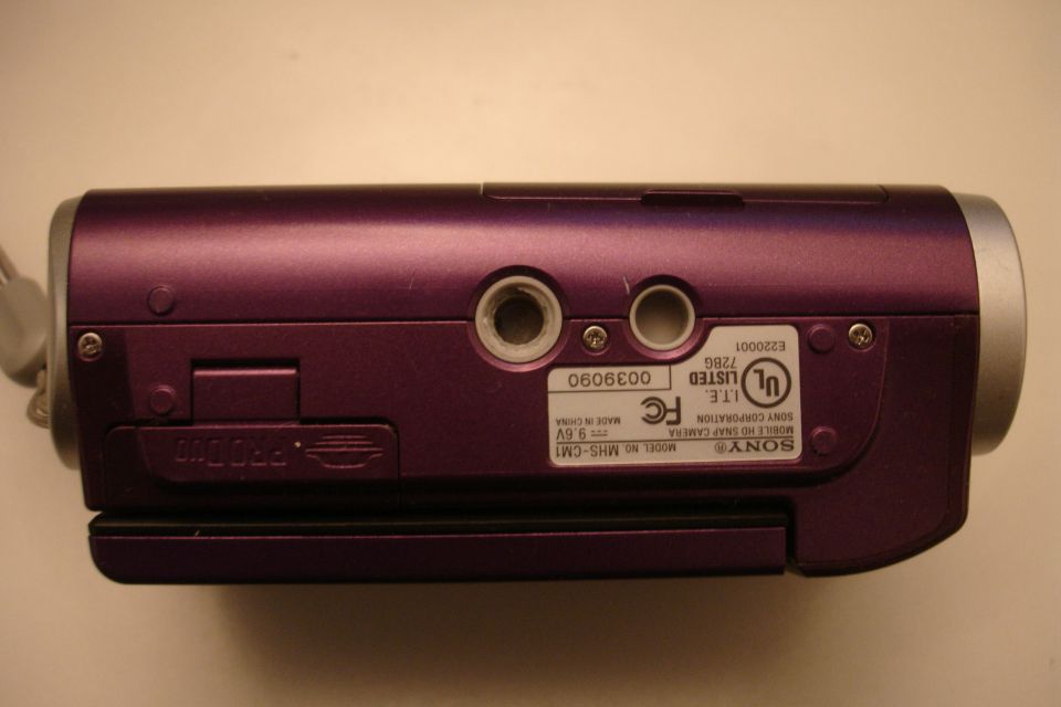 Purple Sony MHS-CM1 digital camera with PRO DUO slot and ports