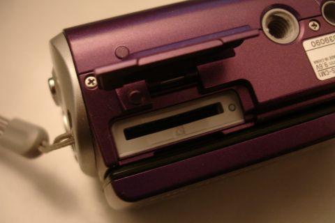 1993 Ford Taurus - Digital camera memory card slot and battery compartment detail. Text on label indicates 9.6V.