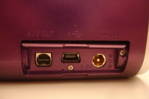 1993 Ford Taurus - Close-up of the rear ports on a purple electronic device, including A/V OUT, USB, and DC IN connections.
