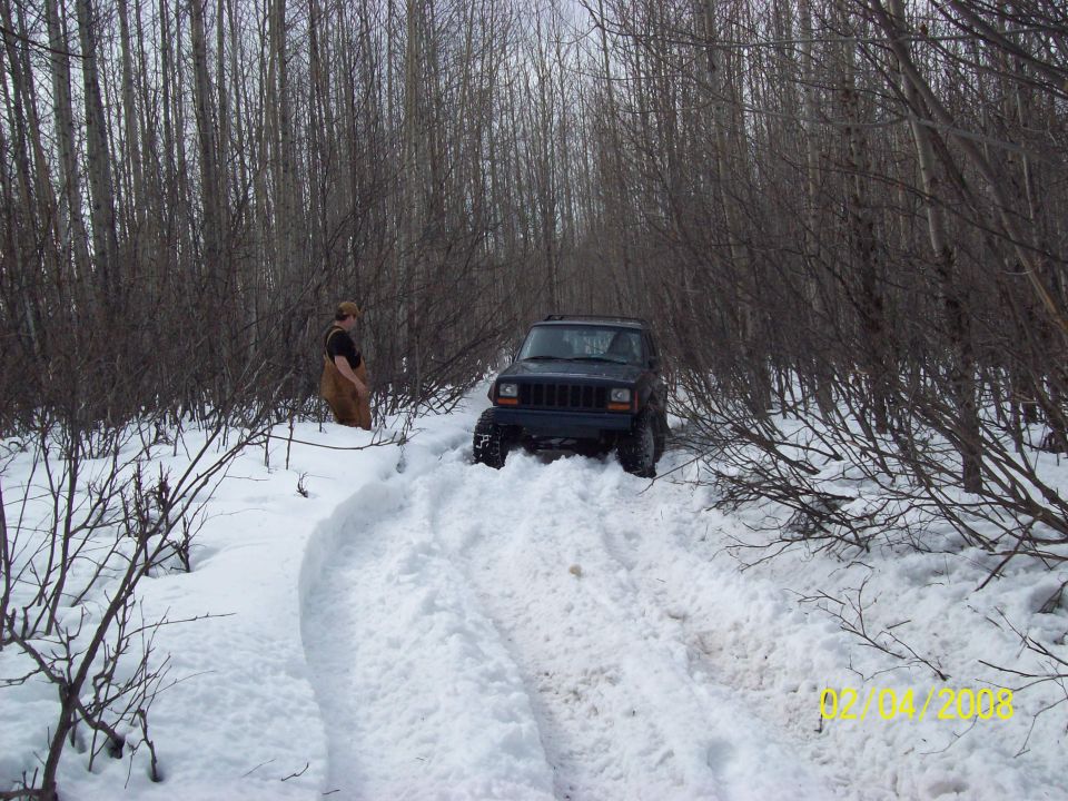 Dark blue Jeep Cherokee XJ in snow