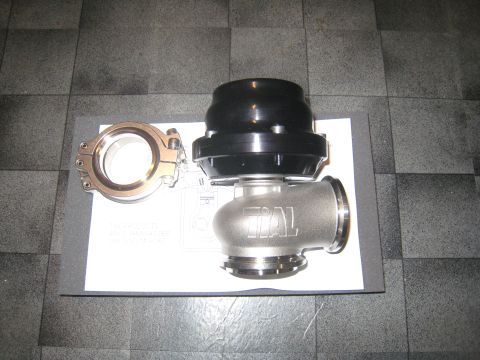 2007 Subaru Impreza - A TiAL external wastegate and V-band clamp are displayed on a document, with a tiled floor in the background.