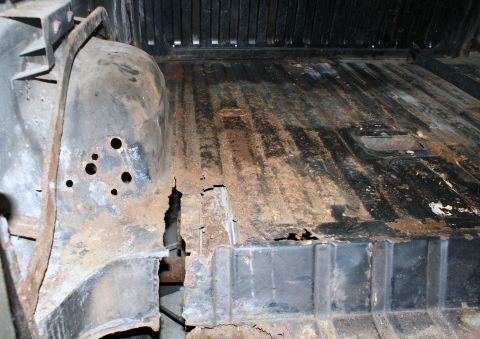 1979 Ford Bronco - The interior of this vehicle shows extensive rust and damage to the floor and wheel well area.