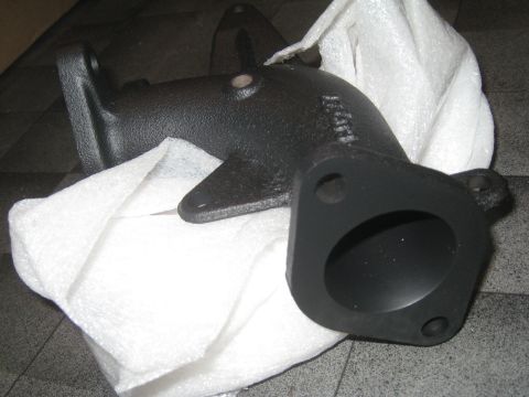 2007 Subaru Impreza - A black cast iron exhaust manifold part is shown, wrapped in white foam padding.