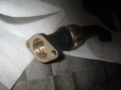 2007 Subaru Impreza - Close-up of an aftermarket exhaust manifold part, likely for an engine modification.