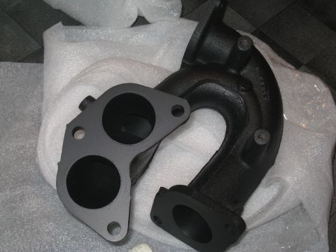 2007 Subaru Impreza - Automotive exhaust manifold and gasket, likely for an engine swap or repair.