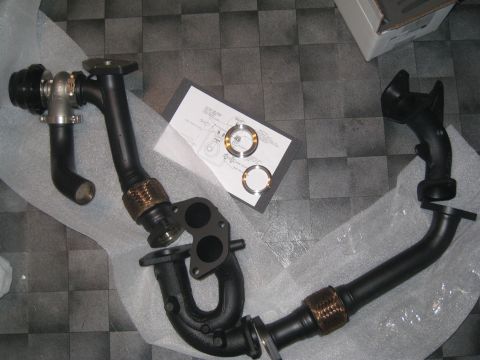 2007 Subaru Impreza - Exhaust manifold with external wastegate and crosspipe, laid out with installation instructions and gaskets.