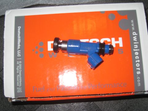 2007 Subaru Impreza - A single blue fuel injector rests on its orange packaging, which displays the DeatschWerks logo and website.