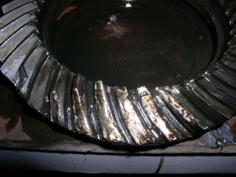 1979 Ford Bronco - A close-up view of a damaged differential gear, showing signs of wear and tear on its teeth.