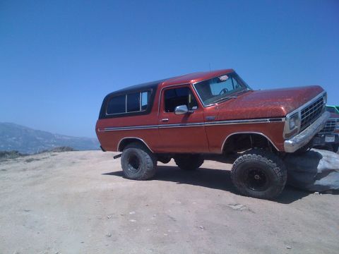 1978 Ford Bronco - This 1978 Ford Bronco is positioned on rocks with a clear blue sky above.
