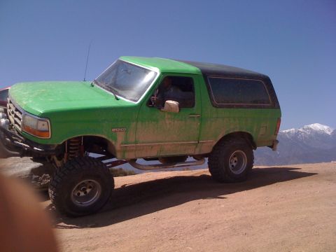 1978 Ford Bronco - This lifted Ford Bronco is shown off-roading with mountains in the distance. It is a 1990s model.