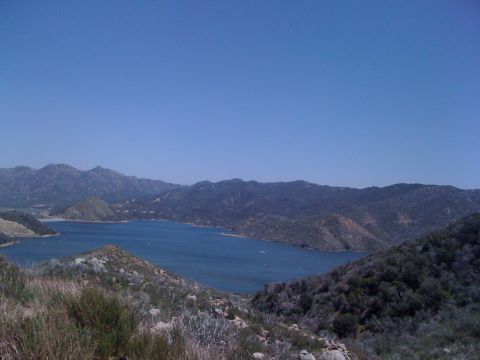 1978 Ford Bronco - A wide view of a lake among rolling hills and mountains on a clear day.