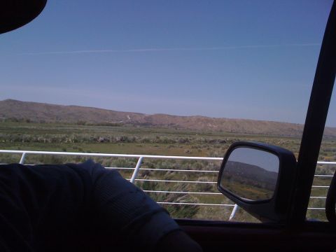 1978 Ford Bronco - Looking out the window of a vehicle at a vast landscape with hills in the distance.