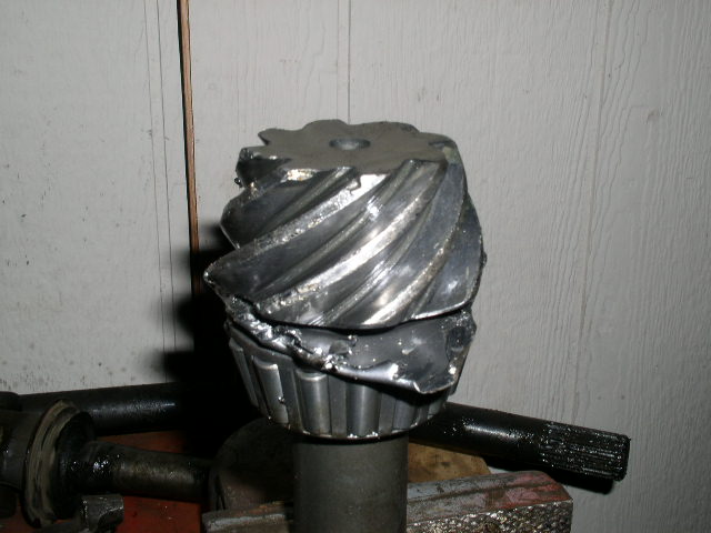 Damaged differential gear with broken teeth and bent metal