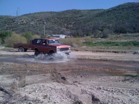 1978 Ford Bronco - 1978 Ford Bronco navigating a water crossing with a trailer in tow.