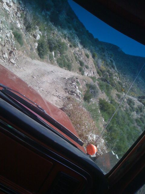 1978 Ford Bronco - Driving on a steep, winding dirt road through a mountainous landscape.