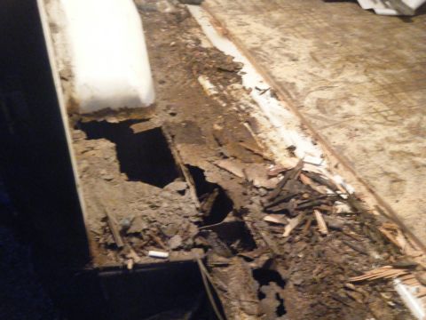 1981 Ford E350 - The floor of the vehicle is severely rotted and filled with debris.