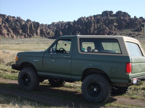 1989 Ford Bronco - This 1987 Ford Bronco is shown in a dry, rocky landscape under a clear blue sky.