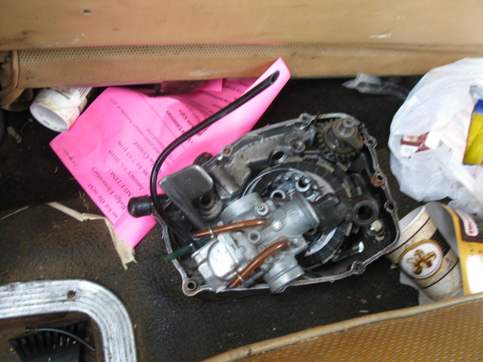 Engine part with carburetor and pink paper