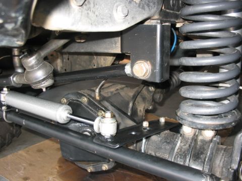 1995 Ford Bronco - Undercarriage view of a vehicle's suspension system, focusing on steering and shock absorber components.