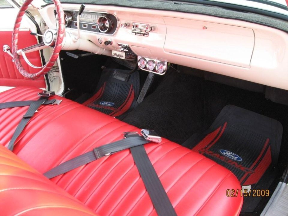 1965 Ford Ranchero interior with red bench seat, white dash, triple gauge pod, and Ford Racing floor mats