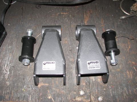 1990 Chevrolet Suburban - Two lift kit brackets and bushings are shown, with visible branding and contact information on the brackets.