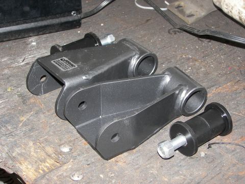 1990 Chevrolet Suburban - These appear to be suspension lift components, possibly for a truck or SUV, laid out on a workbench.