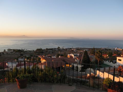 1986 Ford Bronco - A scenic view of a coastal town during sunset, overlooking the ocean with distant islands on the horizon.