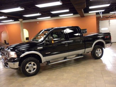 Black and silver Ford F-250 Super Duty pickup truck, crew cab, long bed
