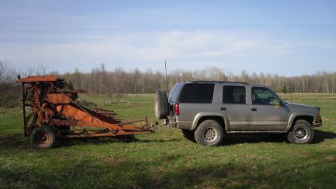 2000 Chevrolet Tahoe - Silver 2000 Chevrolet Tahoe is seen from the side, hitched to a piece of agricultural machinery.