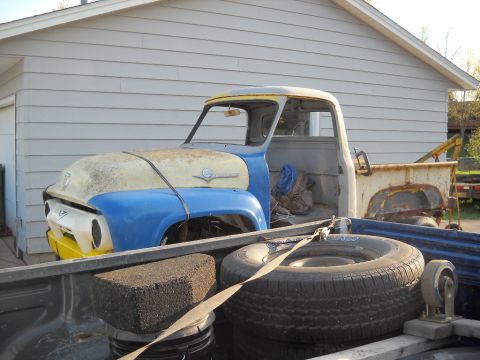1954 Ford F-100 - A vintage pickup truck, likely from the early to mid-1950s, is parked in front of a residential building.