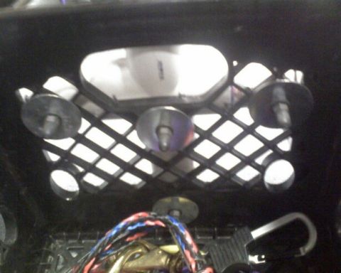 1953 Ford Mainline - Close-up of an interior vehicle component, a diamond-patterned grille and exposed wiring.