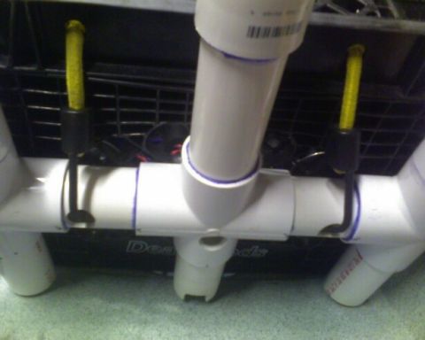 1953 Ford Mainline - Close-up of a PVC pipe structure with yellow cords and black clips.