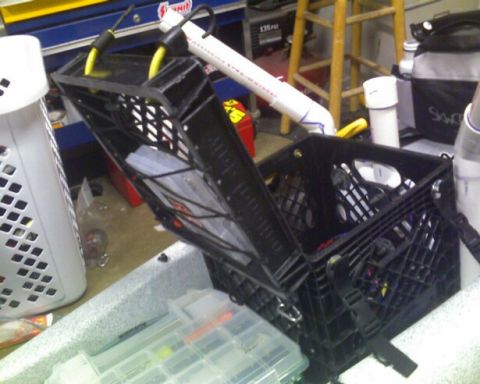 1953 Ford Mainline - Fishing gear and storage crates are organized within a kayak.
